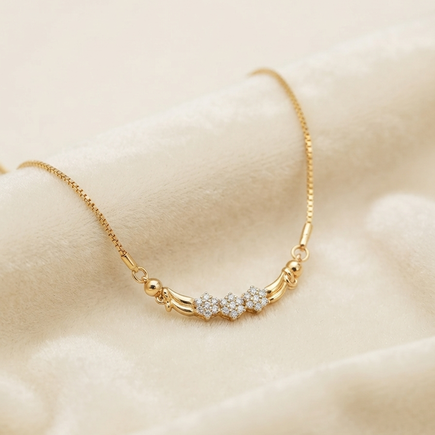 A delicate rose gold necklace with a small central charm, resting on a soft, textured cream-colored fabric background.
